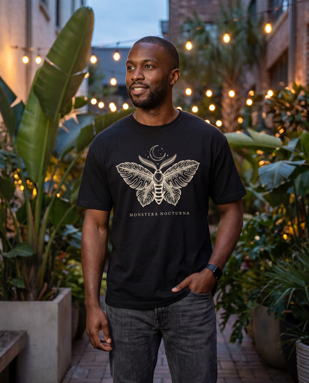 Man wearing the Monstera Nocturna moth tee in Black