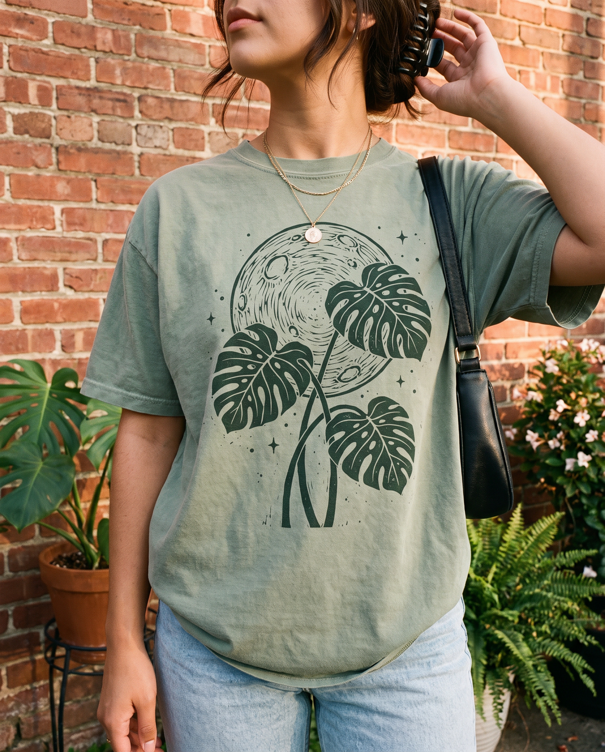 Woman wearing the Moon Monstera tee in Bay