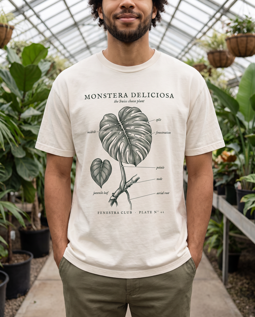 Man wearing the Monstera Deliciosa Plate Nº 01 tee in Ivory in a greenhouse
