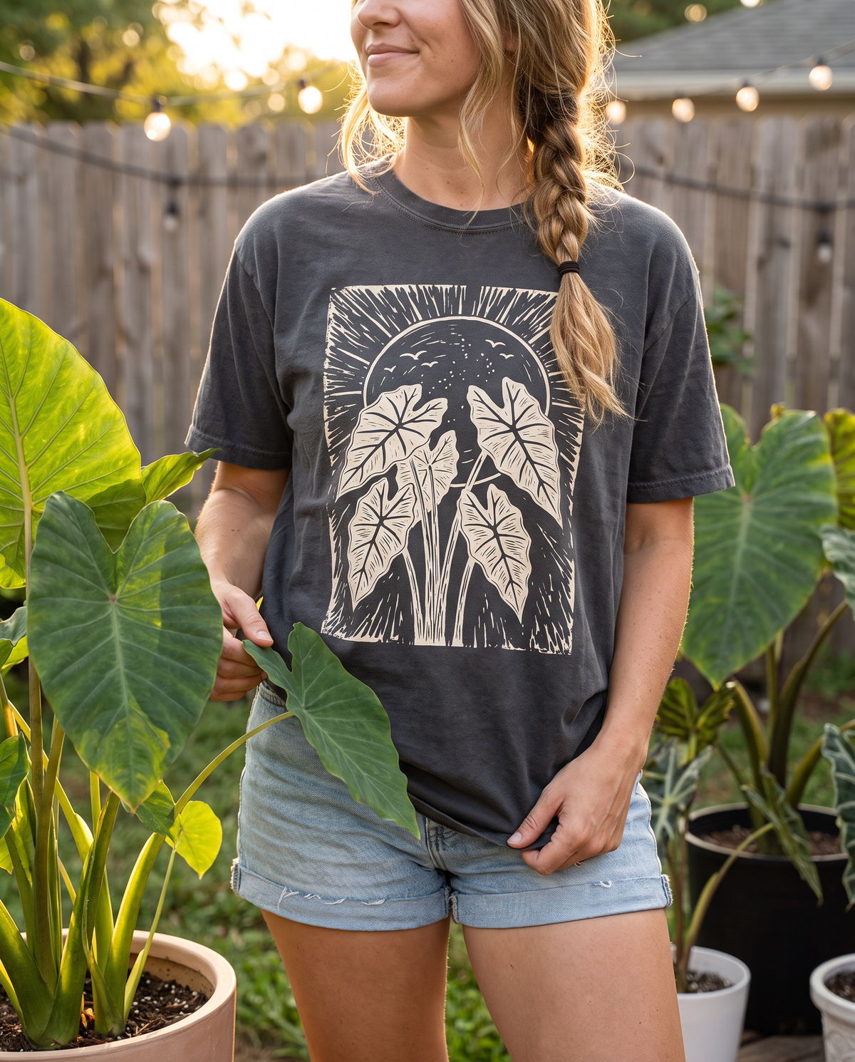 Woman wearing the Sun Alocasia tee in Pepper